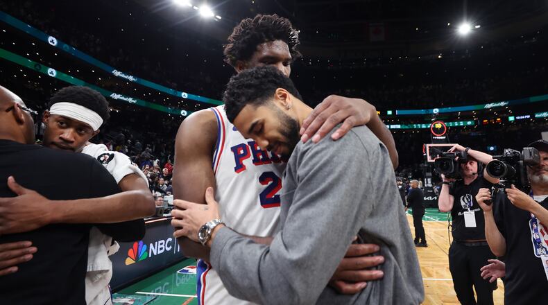 Boston Celtics' Jayson Tatum (right) and Philadelphia 76ers' Joel Embiid (left) embrace following Philadelphia's victory in Game 7 in a first-round NBA basketball playoffs series, Saturday, May 2, 2026 in Boston. (AP Photo/Jim Davis)