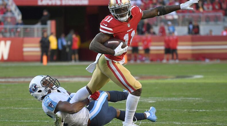 SANTA CLARA, CA - DECEMBER 17:  Marquise Goodwin #11 of the San Francisco 49ers tries to fight off the tackle of LeShaun Sims #36 of the Tennessee Titans late in the fourth quarter of their NFL football game at Levi's Stadium on December 17, 2017 in Santa Clara, California.  (Photo by Thearon W. Henderson/Getty Images)