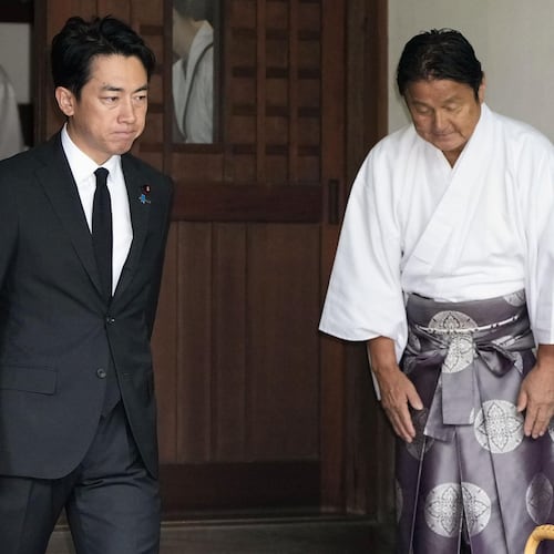 Japan's Defense Minister Shinjiro Koizumi, center, visits Yasukuni Shrine in Tokyo, Saturday, Aug. 15, 2026. (Kyodo News via AP)