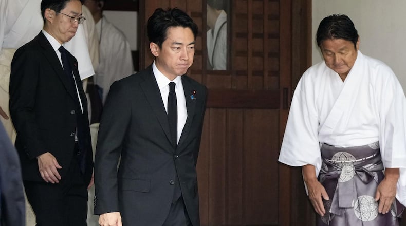 Japan's Defense Minister Shinjiro Koizumi, center, visits Yasukuni Shrine in Tokyo, Saturday, Aug. 15, 2026. (Kyodo News via AP)