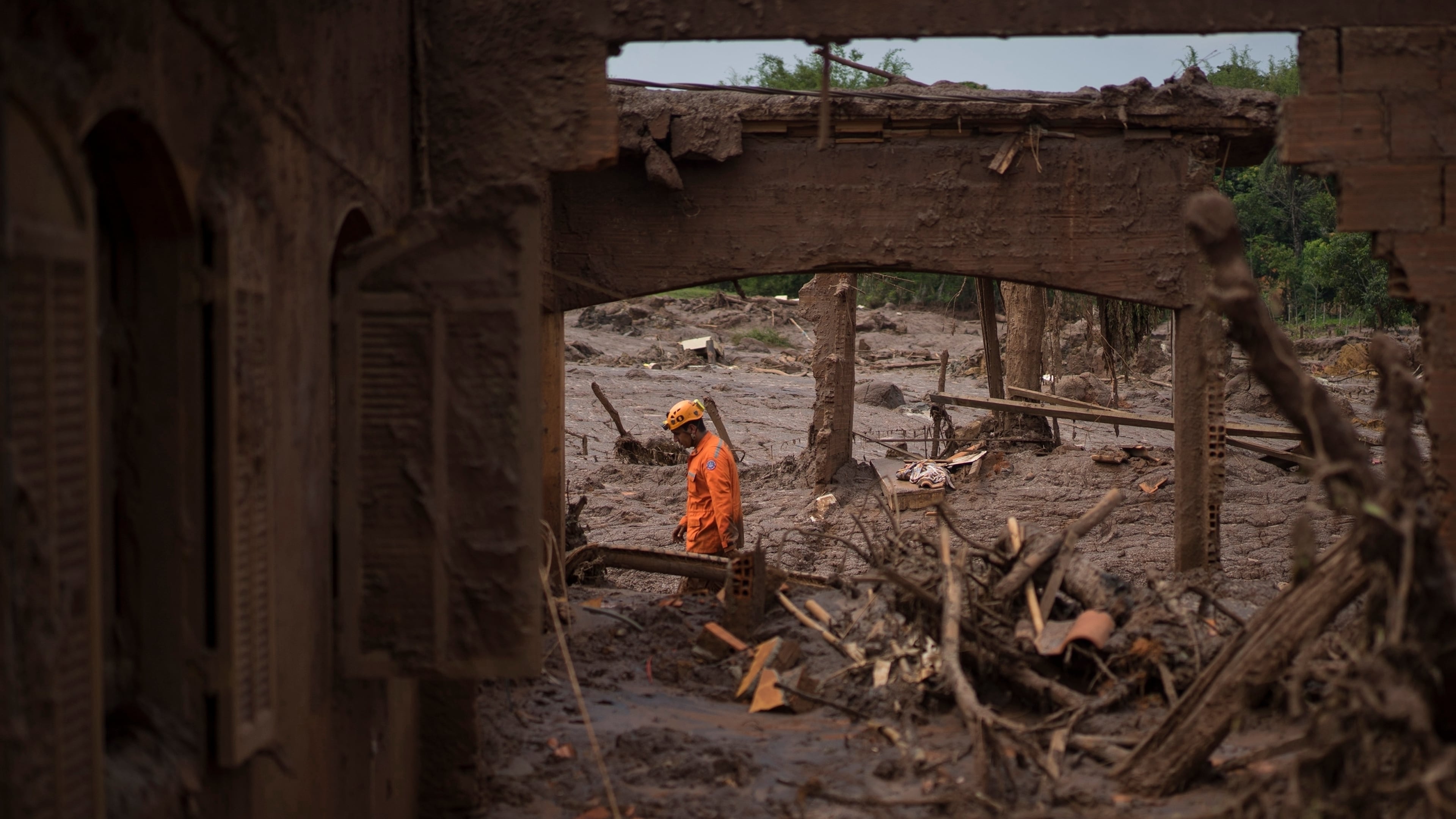 FILE - A rescue worker walks between destroyed houses after a dam burst in the town of Bento Rodrigues, Minas Gerais state, Brazil, Nov. 8, 2015. (AP Photo/Felipe Dana, File)