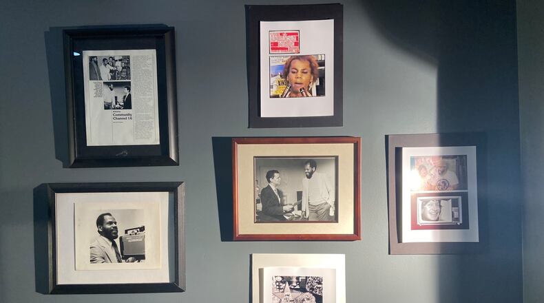 Photos memorializing past eras of Atlanta's public access television station are hung on the walls of its new studio space. (Savannah Sicurella / the AJC)