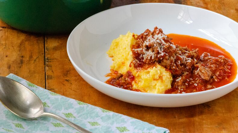 Creamy polenta with spicy turkey sausage arrabbiata topped with freshly grated Parmesan cheese is a hearty dish that's perfect during cold months.
(Virginia Willis for The Atlanta Journal-Constitution)