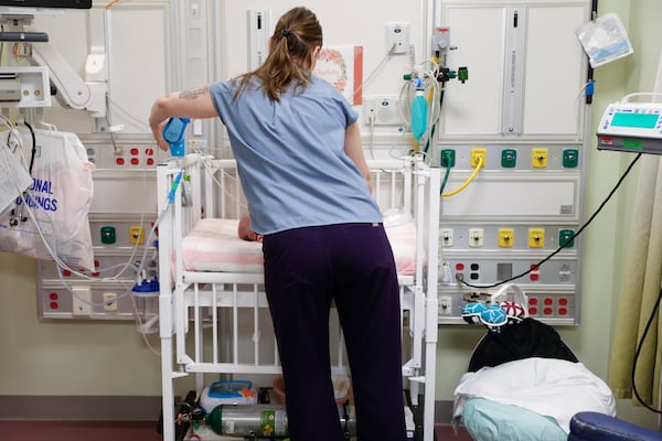 Jessica Bullock, a nurse in the newborn intensive care unit at Children’s Healthcare of Atlanta Egleston cares for a newborn in October 2023. (Natrice Miller/AJC)