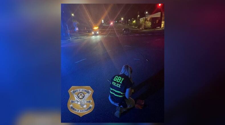 A GBI agent investigates the scene of an officer-involved shooting in Macon on Wednesday evening.