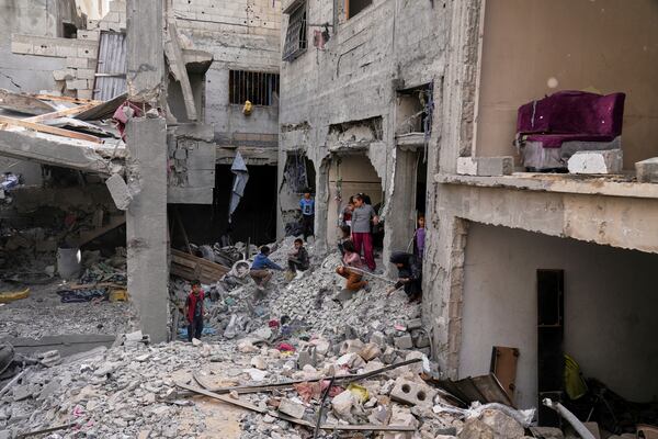 Palestinians inspect the rubble of the Al-Lahham family's home, destroyed by Israeli airstrikes in Khan Younis, Gaza Strip, on Thursday, May 15, 2025. (AP Photo/Abdel Kareem Hana)