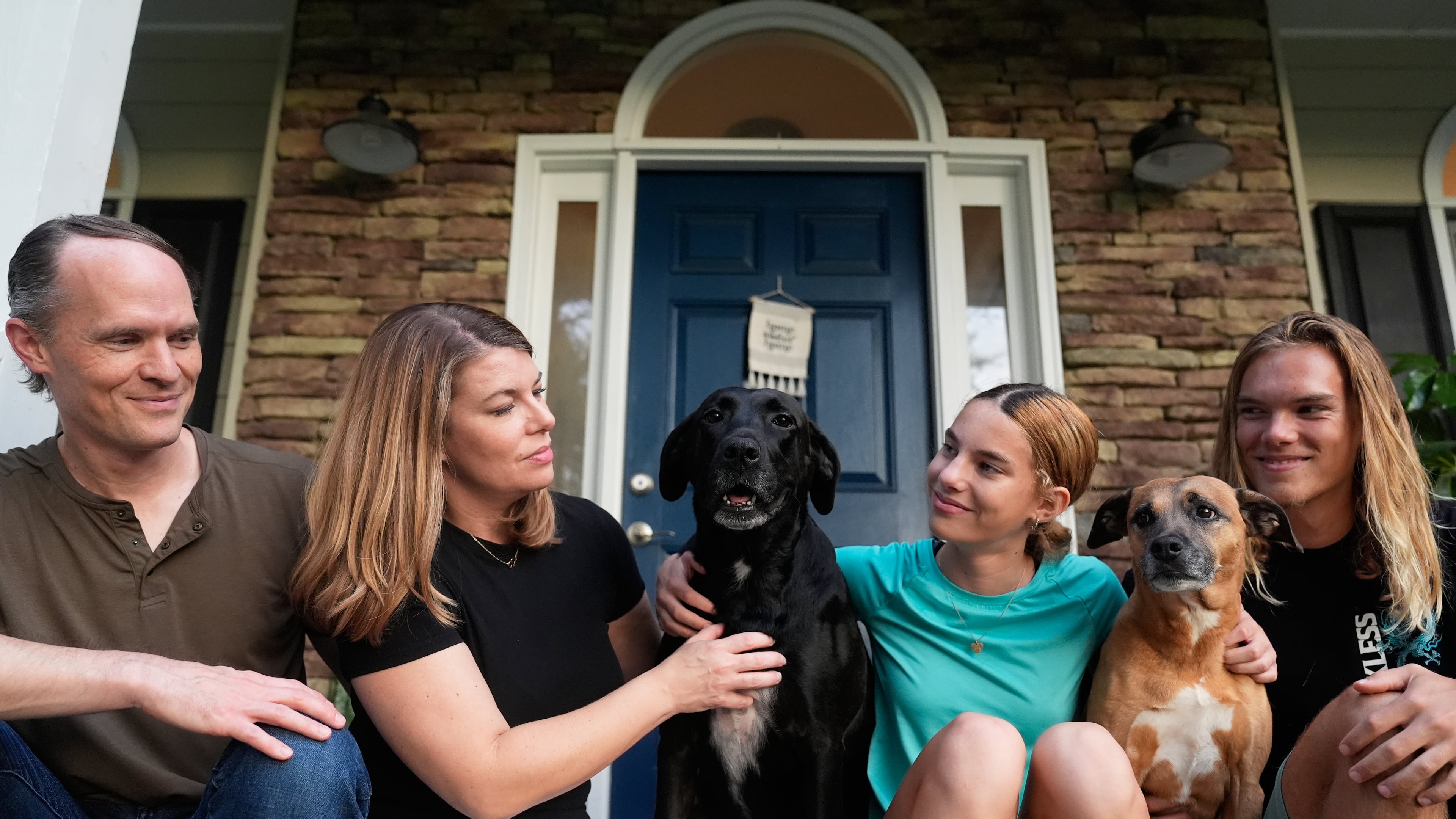 Meaghan and Chris Marr pose with their children and dogs for a photograph on Thursday, Sept. 25, 2025, in Cartersville, Ga. (AP Photo/Brynn Anderson)