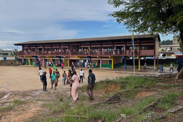 Voters queue to cast their votes for the presidential elections outside a polling station, in Liberville, Gabon, Saturday, April 12, 2025. (AP Photo/Betines Makosso)