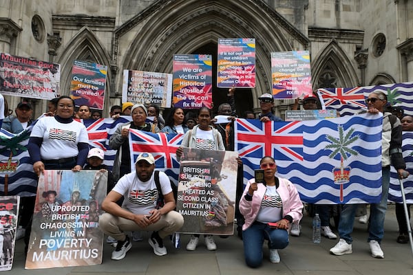 People demonstrate outside the High Court in London, Thursday, May 22, 2025, after a British court blocked the U.K. from transferring sovereignty over the Chagos Islands to Mauritius hours before the agreement was due to be signed. (AP Photo/Thomas Krych)