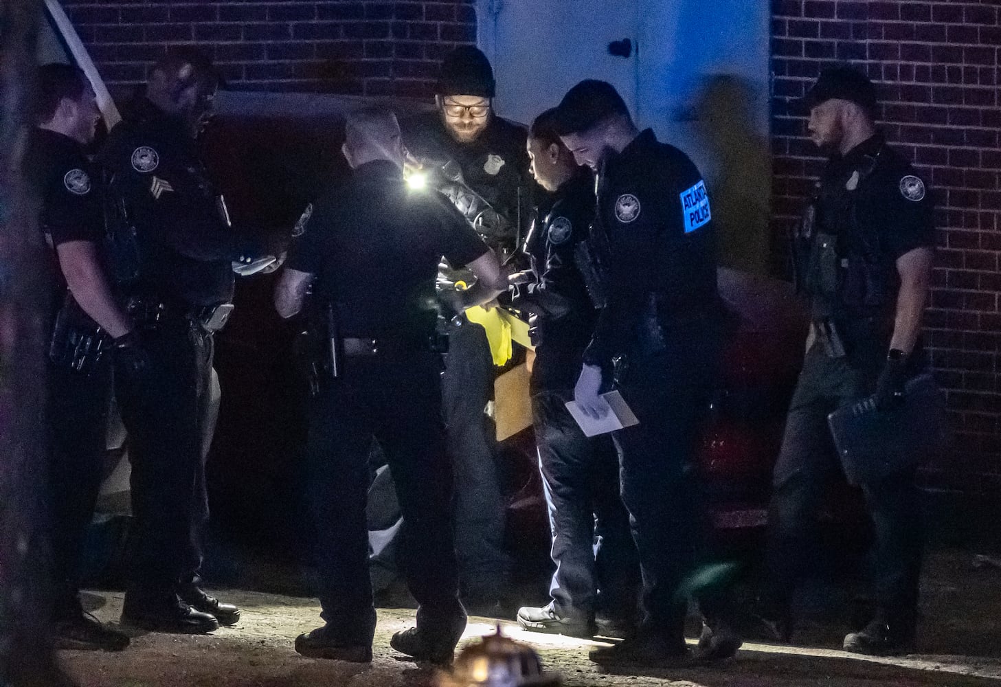 A man is dead and another is injured after gunfire broke out early Friday morning, March 22, 2024 in a parking lot at a busy northeast Atlanta intersection, according to officials. Atlanta police said they got the call about a person shot shortly before 5 a.m. It happened in the parking lot of the old Rhodes Bakery building, which has since been closed, at the corner of Cheshire Bridge Road and Windemere Drive in the Morningside-Lenox Park neighborhood. Authorities said the injured man was shot multiple times in the leg and was undergoing surgery at Grady Memorial Hospital. He is expected to survive, but the other man died at the scene, officials said. Details are limited, but investigators said they believe a “narcotics transaction” is what precipitated the shooting, and it appears both men shot each other. Officers and crime scene investigators worked the scene throughout most of the morning looking for and documenting evidence. (John Spink / John.Spink@ajc.com)