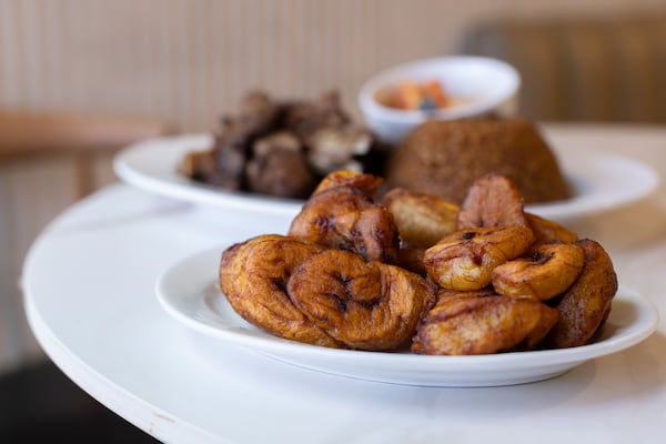 Debee with thieb rice and plantains at Le Nouveau Maquis on Saturday, June 6, 2026 in Tucker, Ga. (Frankie Cole for the AJC)