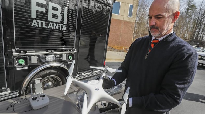 FBI Special Agent John Cronier with one of the six captured drones on Friday, Feb. 1, 2019, at the FBI Field Office in Atlanta.