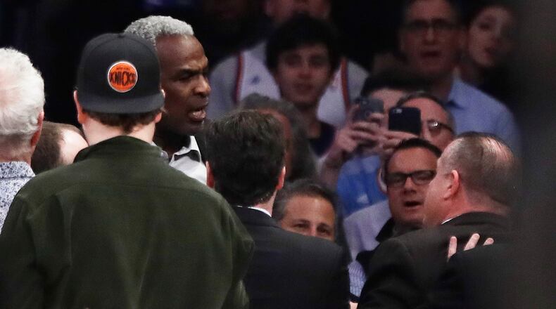 FILE - Former New York Knicks player Charles Oakley, rear left, exchanges words with a security guard during the first half of an NBA basketball game between the Knicks and the Los Angeles Clippers in New York on Feb. 8, 2017. (AP Photo/Frank Franklin II, File)