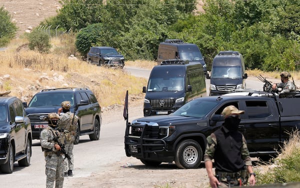 Forces of the regional Kurdish administration secure the area of the Jasana Cave ahead of a symbolic disarmament ceremony by the separatist PKK group as part of the peace process with Turkey, in Sulaymaniyah governorate, Iraq, Friday, July 11, 2025. (AP Photo/Hadi Mizban)
