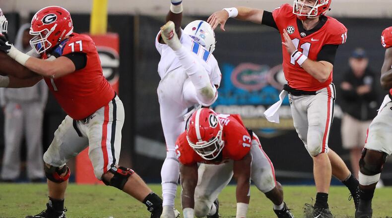 Georgia quarterback Jake Fromm completes a pass under pressure against Florida.