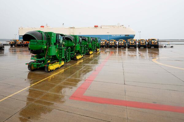 As a ship departs, heavy machinery is seen parked at the Georgia Port Authority in Brunswick, Ga. (Miguel Martinez/AJC)
