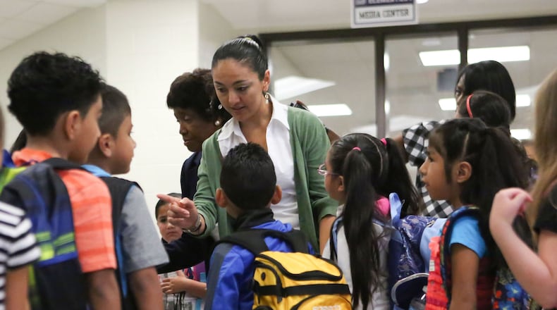 Baldwin Elementary School in Norcross welcomes students into the building on their first day back to school on Monday, August 8, 2016. EMILY JENKINS/ EJENKINS@AJC.COM