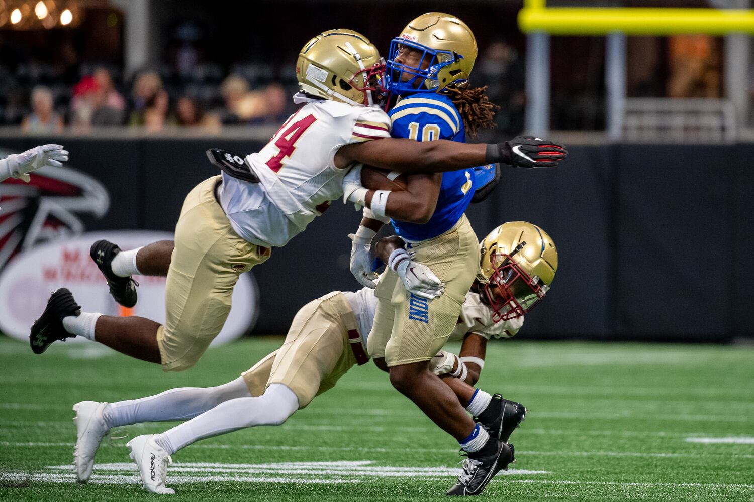 Jayreon Campbell of McEachern, gets tackled by Brookwood players. (Jamie Spaar for the Atlanta Journal Constitution)