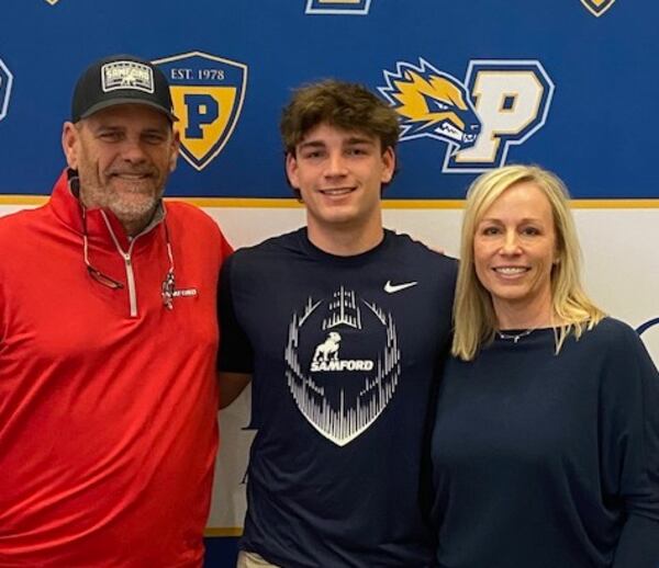 Jake Bobo (center) stands with father, Mike Bobo, and mother, Lainie Bobo, on Thursday morning during his signing ceremony. Jake Bobo, a quarterback at Prince Avenue Christian in Bogart, will be a preferred walk-on at Samford University in Birmingham, Alabama. (Photo courtesy of Prince Avenue Christian School)