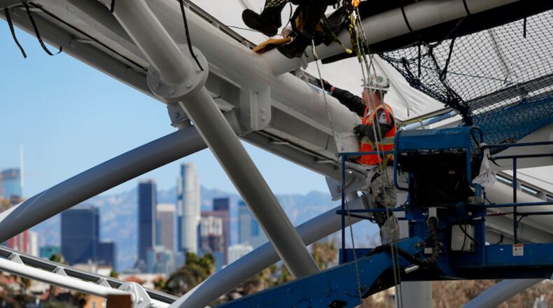 A construction worker installs roof panels on Los Angeles Football Club's Banc of California Stadium in Los Angeles on February 22, 2018. (Allen J. Schaben/Los Angeles Times/TNS)