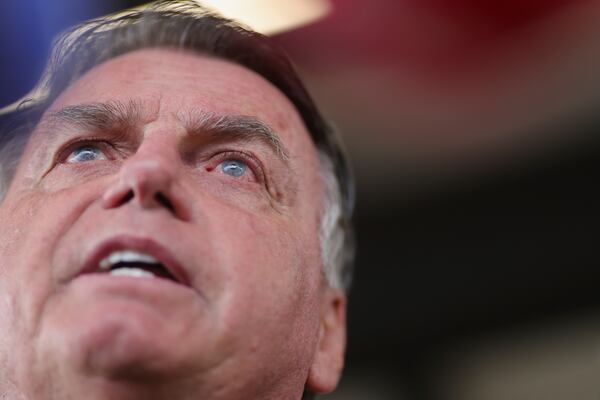 FILE - Brazil's former President Jair Bolsonaro speaks to the media as he arrives at the Brasilia International Airport in Brasilia, Brazil, March 25, 2025. (AP Photo/Luis Nova, File)