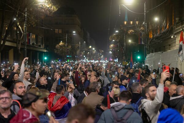 People observe 15 minutes of silence during a massive anti-government rally in Belgrade, Serbia, Saturday, March 15, 2025. (AP Photo/Marko Drobnjakovic)