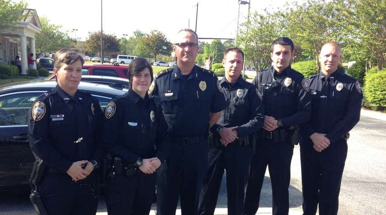 Lilburn’s police chief and five of his officers pay their respects at the funeral of fallen Walmart loss prevention officer J.D. Ferguson in April.