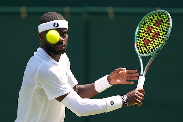 Frances Tiafoe of the U.S. returns the ball to Elmer Moller of Denmark during their first round men's single match at the Wimbledon Tennis Championships in London, Monday, June 30, 2025. (AP Photo/Kirsty Wigglesworth)