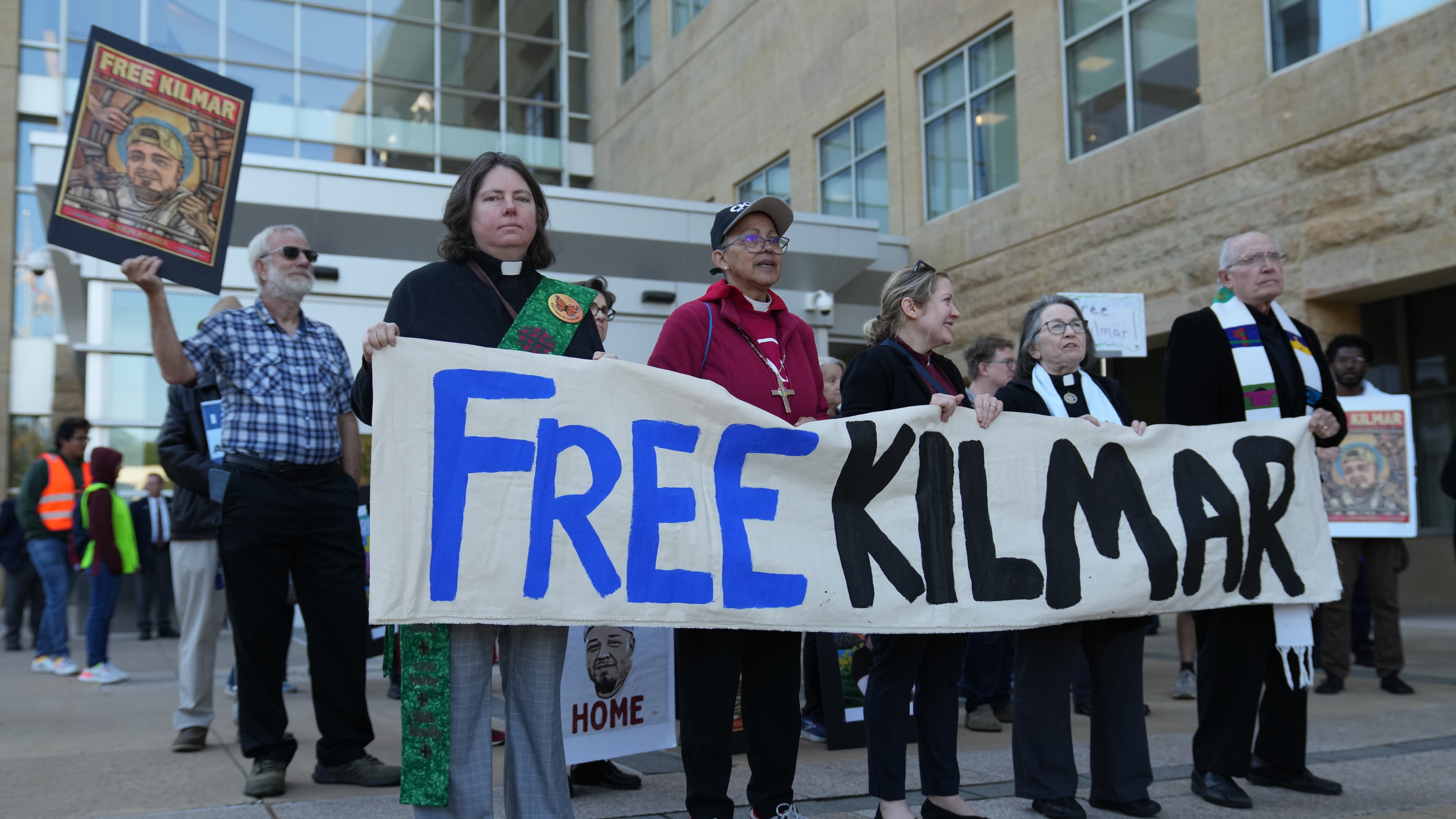 Immigrant activists rally outside of the United States District Court District of Maryland ahead of an evidentiary hearing where attorneys for Kilmar Abrego Garcia will seek his immediate release from immigration detention, Friday, Oct. 10, 2025, in Greenbelt, Md. (AP Photo/Stephanie Scarbrough)