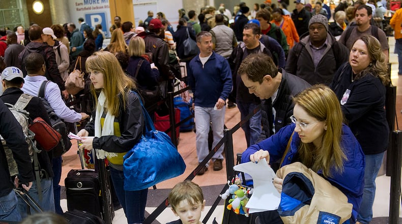 December 1, 2013 Atlanta - Jacquie Carmen (right) waits in the security line at Hartsfield-Jackson International Airport in Atlanta on Sunday, December 1, 2013. JONATHAN PHILLIPS / SPECIAL