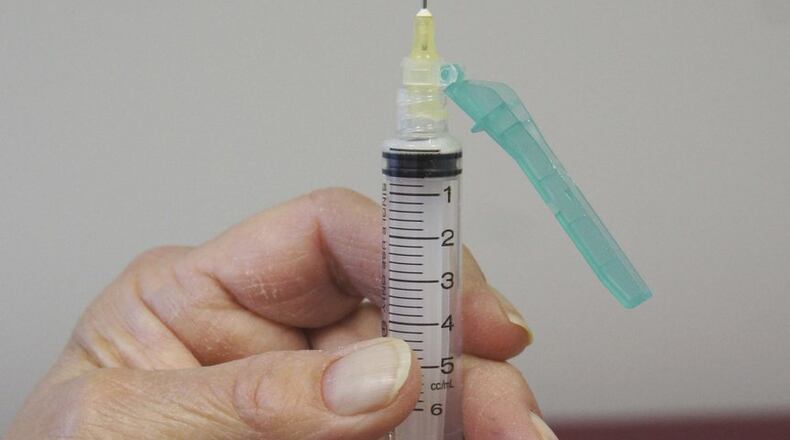 In this Oct. 19, 2016 photo, a nurse at Family Guidance Center, an addiction treatment center in Joliet, Ill., holds a syringe used for Vivitrol, a high-priced monthly injection used to prevent relapse in opioid abusers. U.S. prisons are experimenting with the medication, which could help addicted inmates stay off heroin and other opioid drugs after they are released. (AP Photo/Carla K. Johnson)