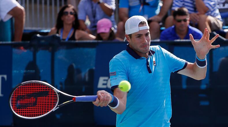 Former UGA player John Isner returns a shot from Ryan Harrison during the BB&T Atlanta Open finals Sunday at Atlantic Station. Isner captured the title by defeating Harrison 7-6 (6), 7-6 (7).