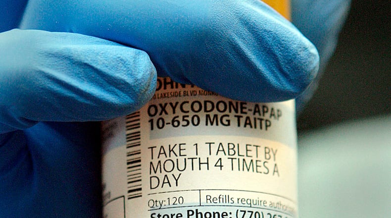 111107 - Decatur - Chuvalo Truesdell, from the DEA, shows a bottle of Oxycodone that was among the pills collected. The DEA, with the assistance of the GBI, began incinerating the 3,794 pounds of pills collected in Georgia during DEA's National Prescription Drug Take-Back event which took place in October. Nov 7, 2011 Bob Andres bandres@ajc.com