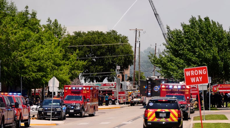 Police and firefighting crews respond to the scene of a large fire at an apartment complex in Dallas, Thursday, May 28, 2026. (AP Photo/Gabriela Passos)