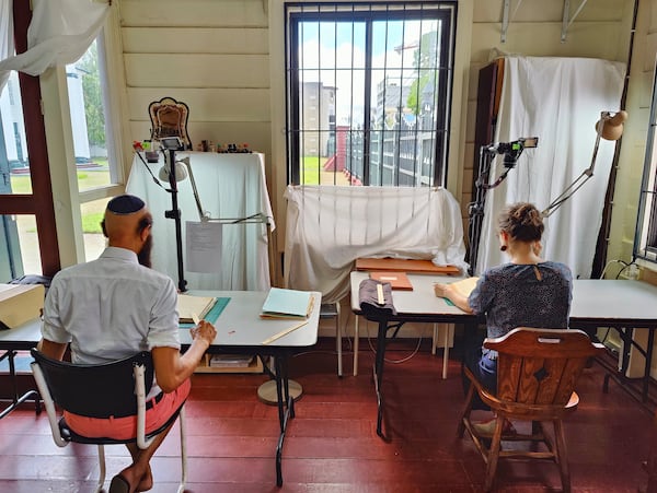 Ronnay Reeder, left, and Rosa de Jong scan images in Paramaribo, Suriname, Friday, May 2, 2025. (AP Photo/Oscar Keur)