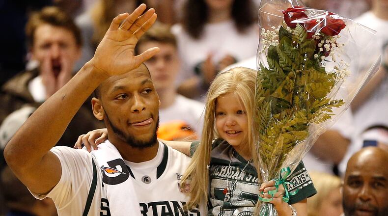 Adreian Payne #5 of the Michigan State Spartans walks on the floor for Senior night with Lacey Holsworth after defeating the Iowa Hawkeyes 86-76 at the Jack T. Breslin Student Events Center on February 6, 2014 in East Lansing, Michigan. (Photo by Gregory Shamus/Getty Images)