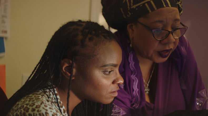 Dazon Dixon Diallo goes over procedures with Tamika English, operations manager at SisterLove.