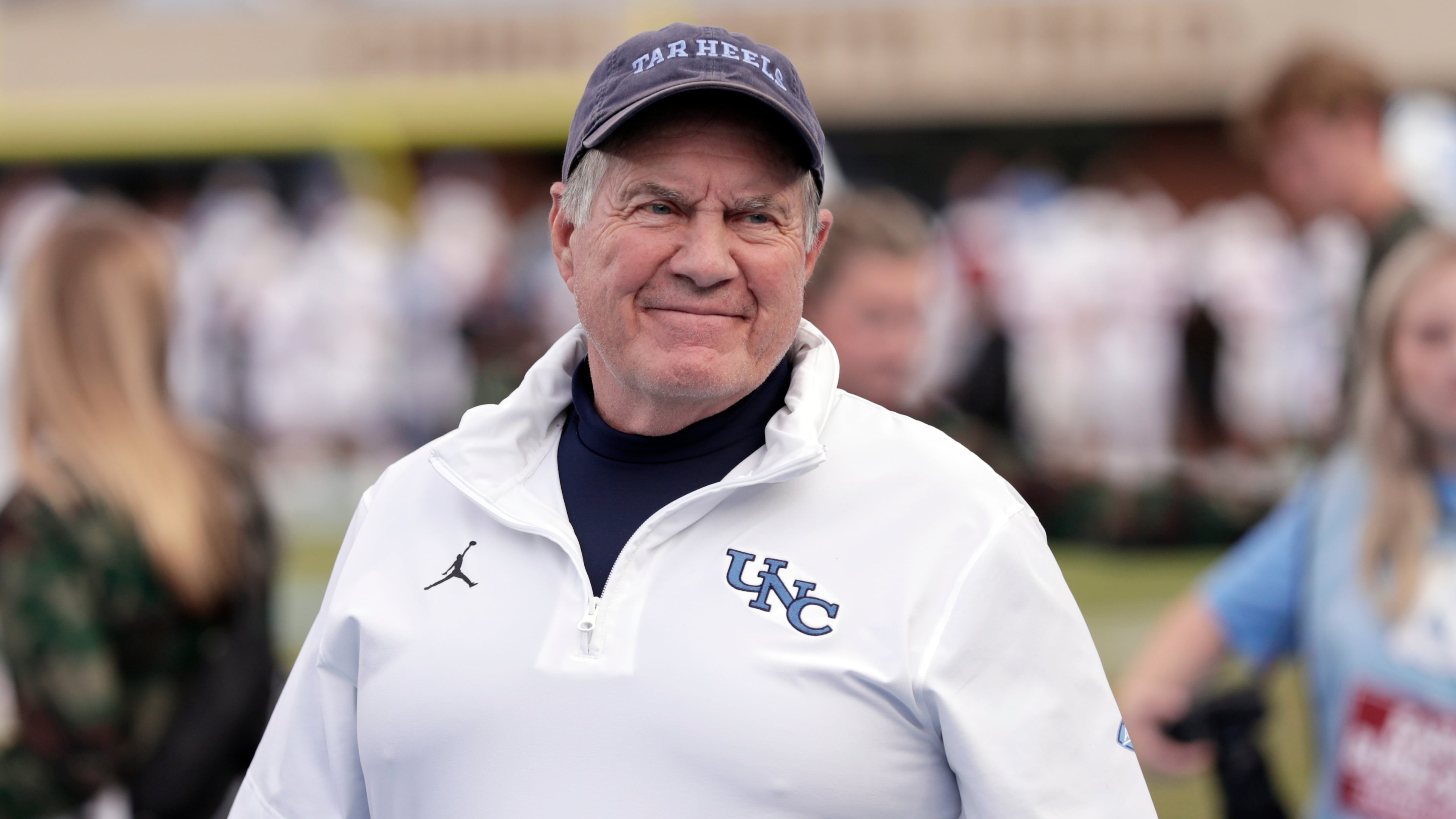 North Carolina head coach Bill Belichick smiles as he walks the sidelines before an NCAA college football game against Stanford, Saturday, Nov. 8, 2025, in Chapel Hill, N.C. (AP Photo/Chris Seward)