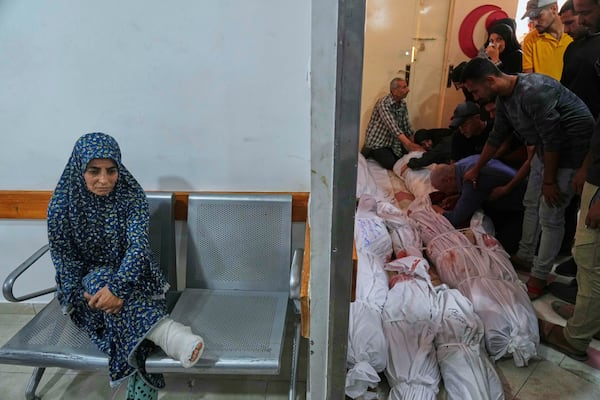 Palestinians mourn their relatives killed in an Israeli airstrikes in Jabalia, northern Gaza Strip, on Wednesday, May 14, 2025. According to local hospitals, 48 people were killed in the strikes, including 22 children. (AP Photo/Jehad Alshrafi)
