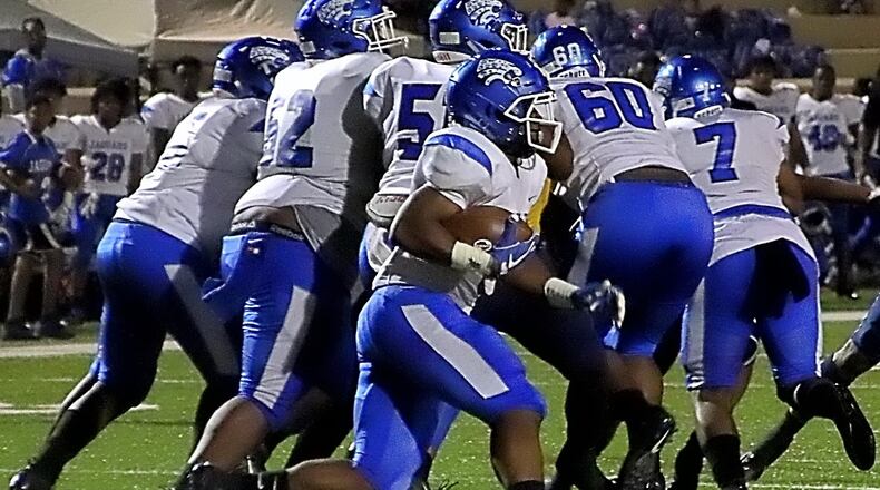 Stephenson running back Ryan Ingram (with ball) runs behind his offensive line. Ingram rushed for 162 yards and three touchdowns in a recent victory over Drew. (Photo by Mark Brock)