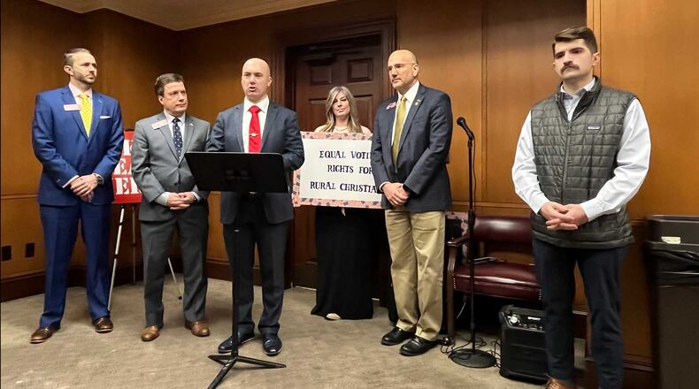 A group launched a program called "Patriotic Souls to the Polls" at the Georgia Capitol to mobilize churchgoers to vote on Sundays. A sign reads, "Equal voting rights for rural Christians." From left: state Rep. Matt Dubnik, Rep. Wes Cantrell, Matt Braynard of Look Ahead America, volunteer coordinator Jennifer Rae Vliet, Rep. Todd Jones, and Dawson Mancabelli of Turning Point Faith, on Tuesday, Feb. 8, 2022. MARK NIESSE / MARK.NIESSE@AJC.COM