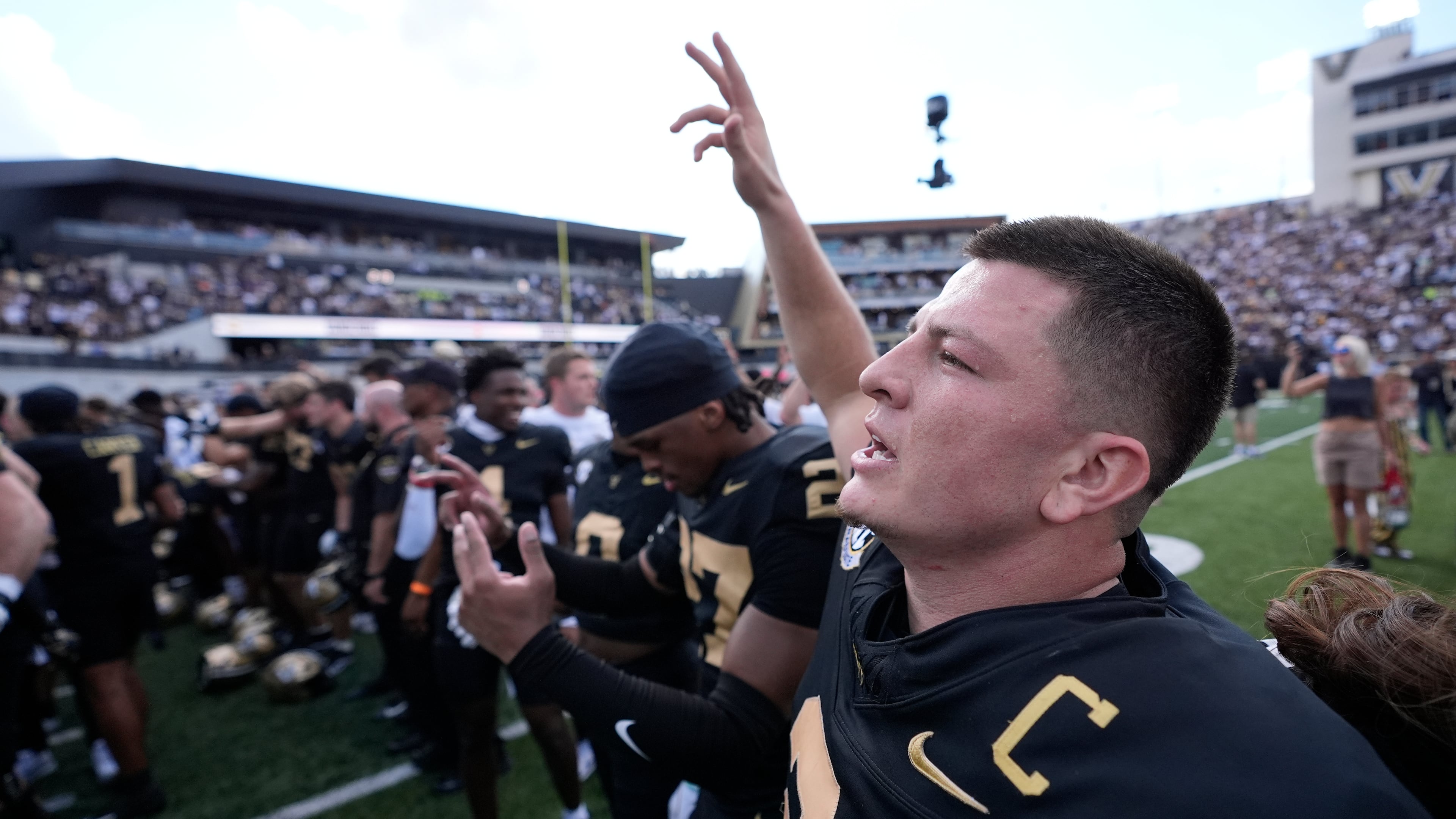 Vanderbilt quarterback Diego Pavia, right, celebrates the team's win with teammates after an NCAA college football game against LSU, Saturday, Oct. 18, 2025, in Nashville, Tenn. (AP Photo/George Walker IV)