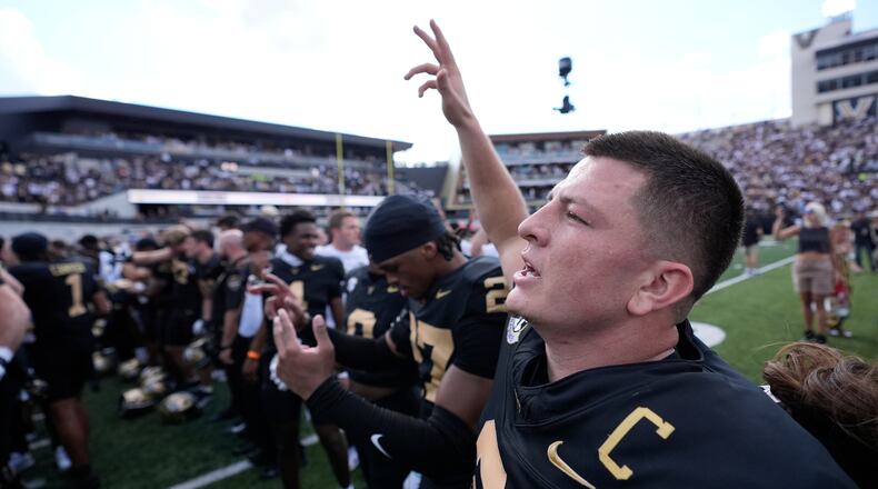 Vanderbilt quarterback Diego Pavia, right, celebrates the team's win with teammates after an NCAA college football game against LSU, Saturday, Oct. 18, 2025, in Nashville, Tenn. (AP Photo/George Walker IV)