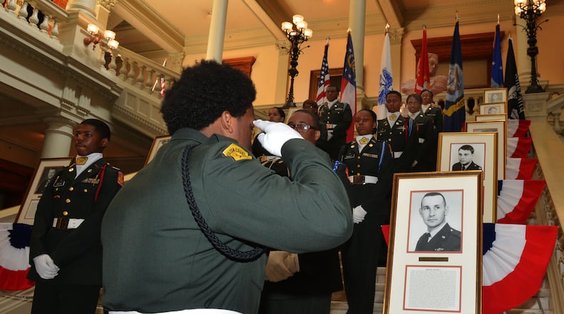Westlake HS Army JROTC member Kedar Leonard salutes the portrait of Air Force Captain Hilliard Willbanks during the ceremony. Veterans, family members and state officials attend a ceremony honoring Medal of Honor recipients from the Vietnam War at the Georgia Capitol Tuesday, March 25, 2014. Twelve Georgians, veterans of the Vietnam War, possess the Medal of Honor. It is the highest accolade this nation gives its warriors. On Tuesday, they were recognized in a special ceremony at the Capitol. Gov. Nathan Deal proclaimed March 29 as Vietnam Veterans Day in Georgia. KENT D. JOHNSON / KDJOHNSON@AJC.COM