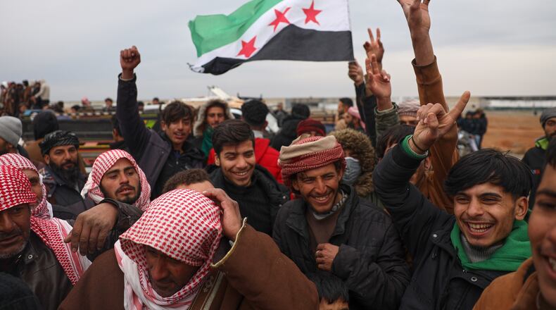 People celebrate as Syrian government forces enter the town of Maskana, Saturday, Jan. 17, 2026, following the withdrawal of the U.S.-backed Syrian Democratic Forces. (AP Photo/Omar Albam)