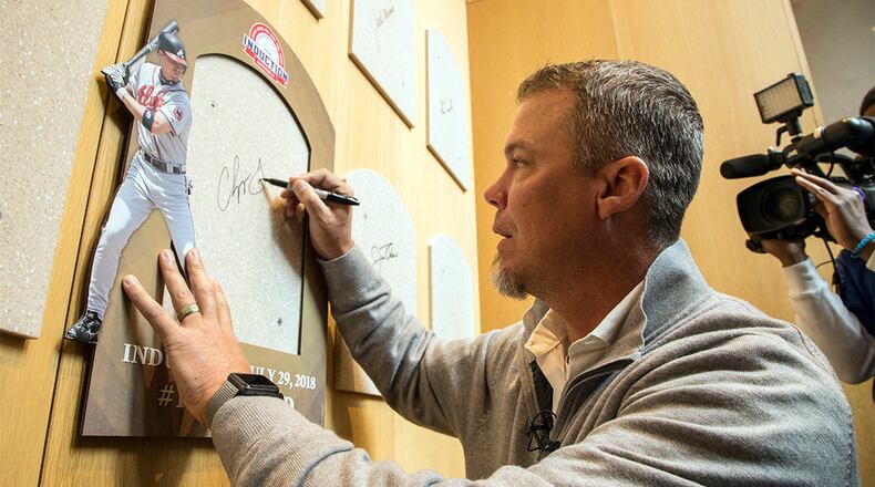 Hall of Fame inductee and former Atlanta Braves slugger Chipper Jones signs the spot where his Hall of Fame plaque will hang during an orientation tour of the National Baseball Hall of Fame in Cooperstown, N.Y., Tuesday, April 10, 2018.