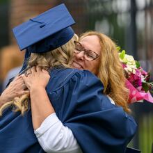 Berry College graduate Kara Schmit gets a hug from her mom, Sue Schmit, Saturday, May 9, 2026. (Courtesy of Brant Sanderlin/Berry College)