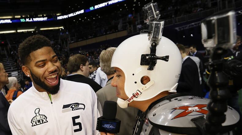 Seattle Seahawks’ B.J. Daniels smiles as he is interviewed by NBC Sports’ Karim Mendiburu Contreras during media day for NFL Super Bowl XLIX football game Tuesday, Jan. 27, 2015, in Phoenix. (AP Photo/Matt York)
