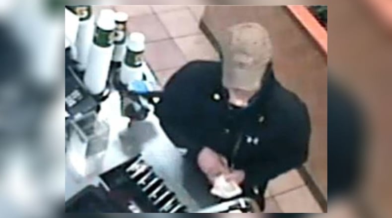Surveillance footage shows a man taking cash from a Subway restaurant in Woodstock during a robbery on New Year's Day.