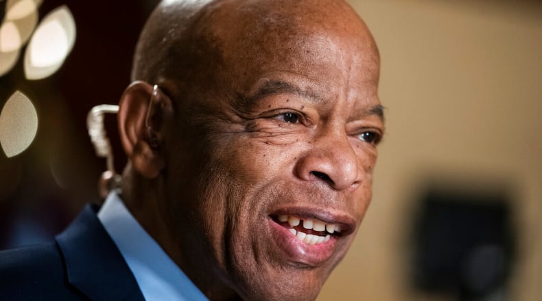 FILE - In this July 16, 2019, file photo, Rep. John Lewis, D-Ga., speaks during a television interview at the Capitol in Washington. Robert E. Lee High School in Virginia has been renamed for the Congressman. (AP Photo/J. Scott Applewhite, File)